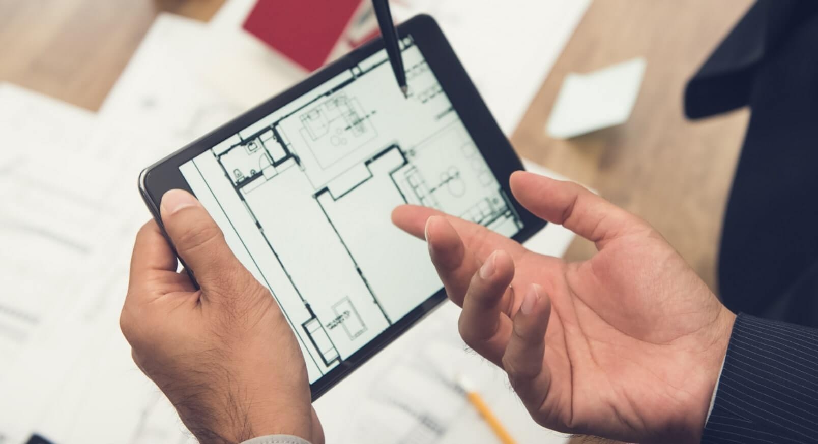 Architects looking a building plan on a tablet